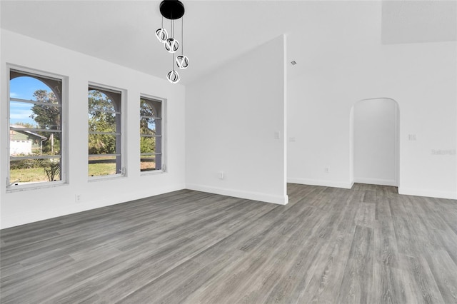 4210 Day St, Port Charlotte, FL 33948 - unfurnished room featuring wood finished floors, lofted ceiling, baseboards, and arched walkways