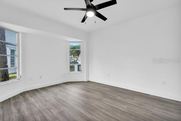4210 Day St, Port Charlotte, FL 33948 - unfurnished room featuring wood finished floors, baseboards, and a ceiling fan