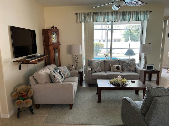 living area featuring light tile patterned floors and a ceiling fan