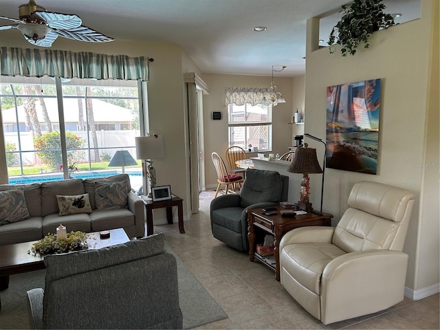 living area featuring ceiling fan, light tile patterned floors, recessed lighting, and baseboards