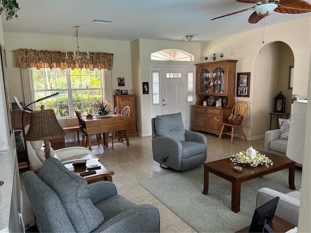 living area with light tile patterned floors, ceiling fan, and baseboards