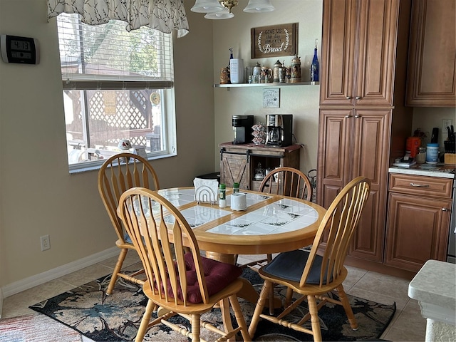 dining area with light tile patterned floors and baseboards