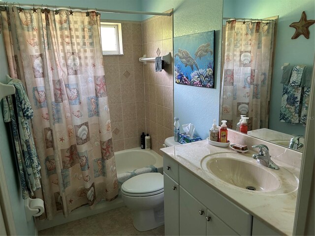 full bathroom featuring shower / bathtub combination with curtain, toilet, vanity, and tile patterned flooring