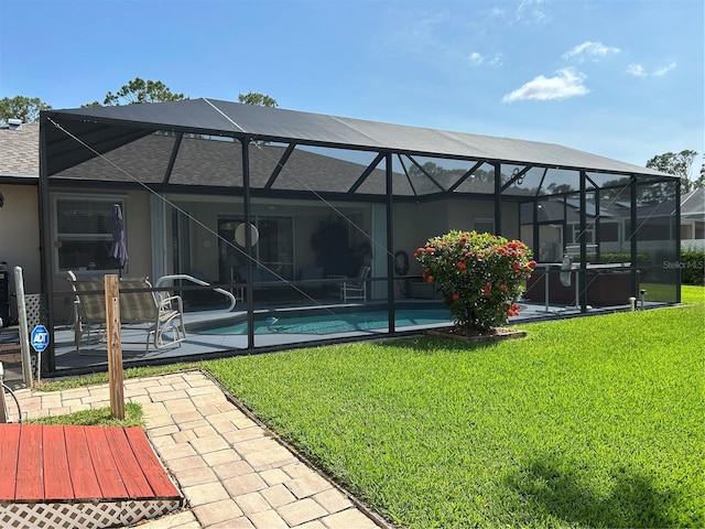 back of house featuring a patio area, an outdoor pool, and a lawn