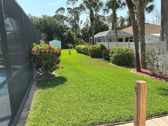 view of yard with glass enclosure