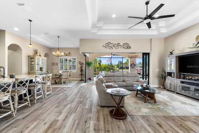 15044 San Domingo Blvd, Port Charlotte, FL 33981 - living area featuring a raised ceiling, arched walkways, plenty of natural light, ornamental molding, and recessed lighting