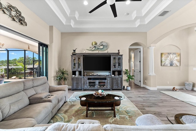 15044 San Domingo Blvd, Port Charlotte, FL 33981 - living room with arched walkways, a raised ceiling, ceiling fan, wood finished floors, and ornate columns