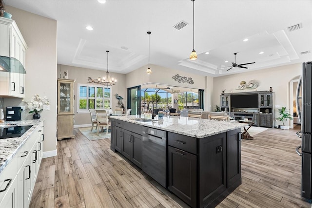 15044 San Domingo Blvd, Port Charlotte, FL 33981 - kitchen featuring a raised ceiling, dishwasher, a sink, white cabinets, and light wood finished floors
