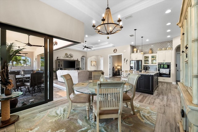 15044 San Domingo Blvd, Port Charlotte, FL 33981 - dining space featuring arched walkways, light wood-style flooring, a chandelier, recessed lighting, and a ceiling fan