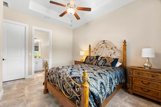 15044 San Domingo Blvd, Port Charlotte, FL 33981 - bedroom featuring a raised ceiling, connected bathroom, ceiling fan, crown molding, and baseboards