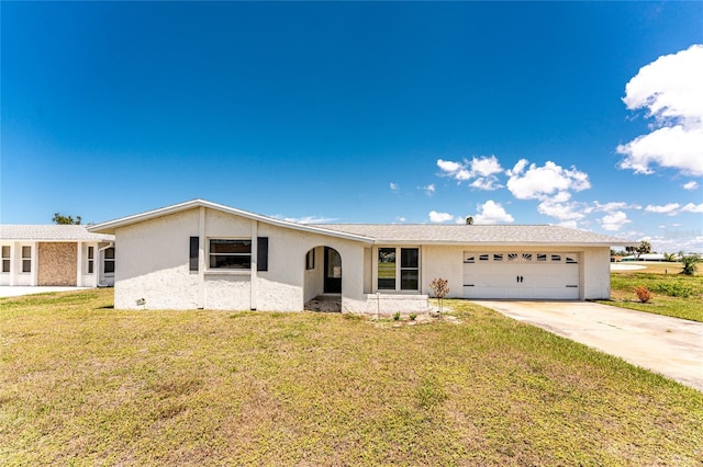 11 Oakland Hills Rd, Rotonda West, FL 33947 - single story home featuring an attached garage, stucco siding, driveway, and a front yard