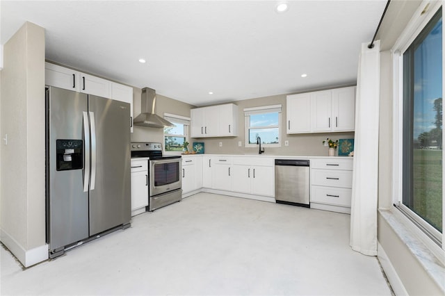 11 Oakland Hills Rd, Rotonda West, FL 33947 - kitchen with appliances with stainless steel finishes, wall chimney range hood, white cabinetry, a sink, and concrete flooring