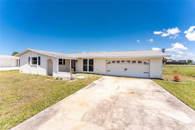 11 Oakland Hills Rd, Rotonda West, FL 33947 - single story home with an attached garage, stucco siding, and a front yard