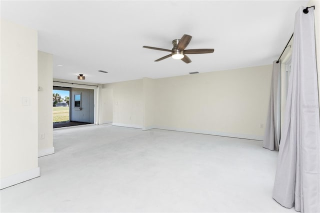 11 Oakland Hills Rd, Rotonda West, FL 33947 - unfurnished room featuring ceiling fan, baseboards, and concrete flooring