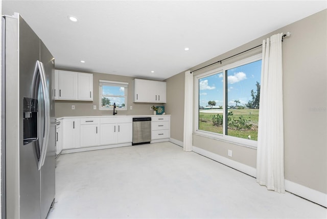 11 Oakland Hills Rd, Rotonda West, FL 33947 - kitchen featuring stainless steel appliances, white cabinetry, light countertops, baseboards, and recessed lighting