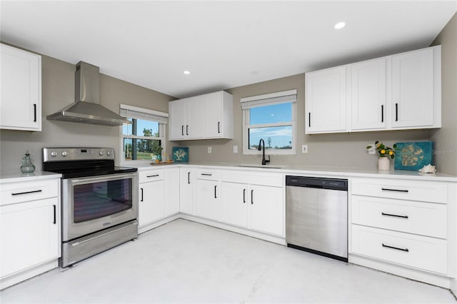 11 Oakland Hills Rd, Rotonda West, FL 33947 - kitchen featuring appliances with stainless steel finishes, wall chimney range hood, a sink, light countertops, and white cabinetry
