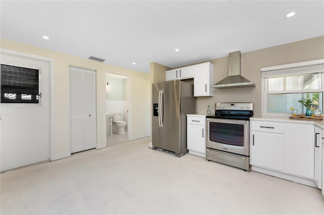 11 Oakland Hills Rd, Rotonda West, FL 33947 - kitchen with wall chimney range hood, stainless steel appliances, white cabinets, light countertops, and recessed lighting