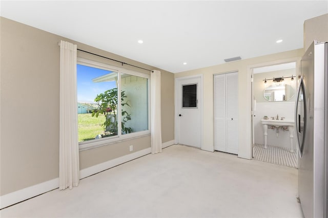 11 Oakland Hills Rd, Rotonda West, FL 33947 - unfurnished bedroom with freestanding refrigerator, recessed lighting, ensuite bathroom, and baseboards