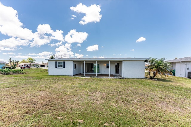 11 Oakland Hills Rd, Rotonda West, FL 33947 - view of front facade with a front yard and stucco siding