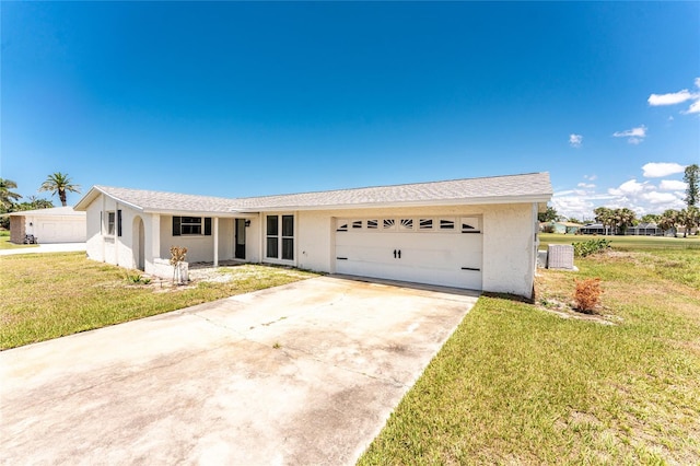 11 Oakland Hills Rd, Rotonda West, FL 33947 - ranch-style house featuring an attached garage, a front lawn, stucco siding, driveway, and central air condition unit