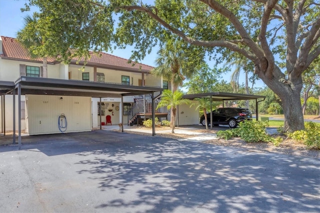 507 Pine Hollow Cir Unit 507, Englewood, FL 34223 - view of front of property with covered parking, stairway, and a tiled roof