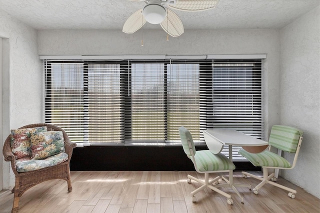507 Pine Hollow Cir Unit 507, Englewood, FL 34223 - sitting room with a textured wall, wood finished floors, a textured ceiling, and ceiling fan