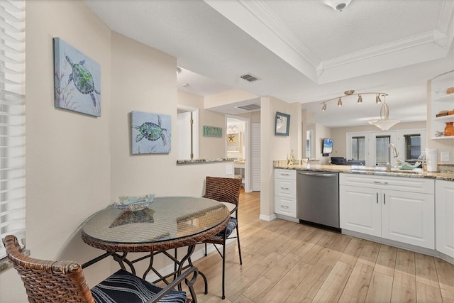 507 Pine Hollow Cir Unit 507, Englewood, FL 34223 - kitchen with stainless steel dishwasher, a sink, light wood finished floors, ornamental molding, and a tray ceiling