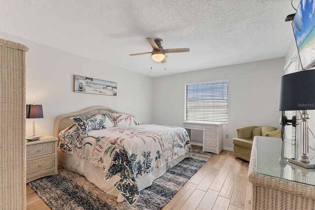 507 Pine Hollow Cir Unit 507, Englewood, FL 34223 - bedroom featuring wood finished floors, ceiling fan, a textured ceiling, and baseboards