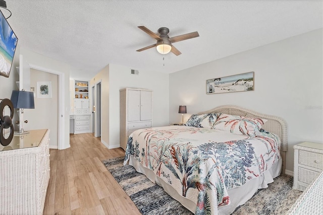 507 Pine Hollow Cir Unit 507, Englewood, FL 34223 - bedroom with light wood-style flooring, baseboards, and a ceiling fan