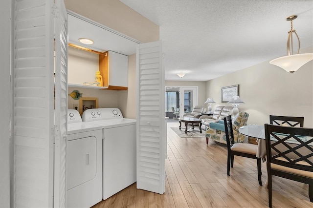 507 Pine Hollow Cir Unit 507, Englewood, FL 34223 - washroom with separate washer and dryer and light wood-style flooring