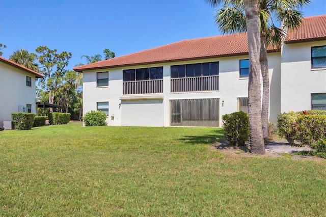 507 Pine Hollow Cir Unit 507, Englewood, FL 34223 - rear view of property featuring stucco siding, a tile roof, and a yard