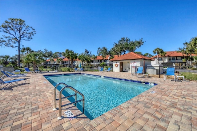 507 Pine Hollow Cir Unit 507, Englewood, FL 34223 - community pool with fence, a patio, and a residential view