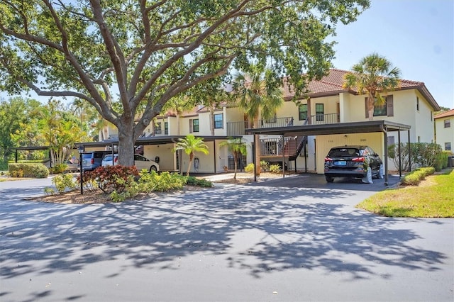 507 Pine Hollow Cir Unit 507, Englewood, FL 34223 - multi unit property with stairway, a tile roof, and stucco siding