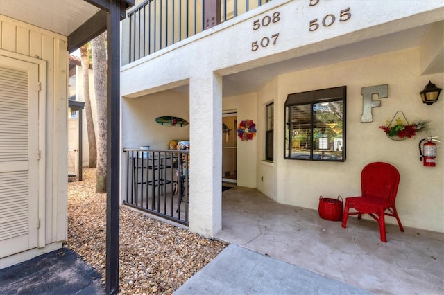 507 Pine Hollow Cir Unit 507, Englewood, FL 34223 - doorway to property with stucco siding and a balcony