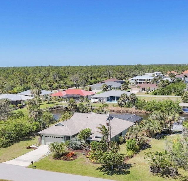 aerial view of property and surrounding area featuring a forest