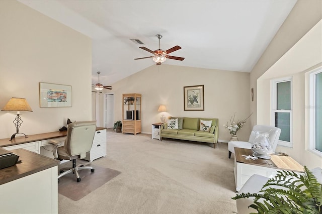office area with vaulted ceiling, light carpet, ceiling fan, and baseboards
