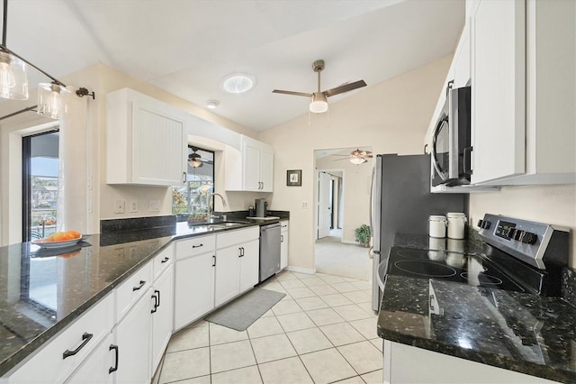 kitchen with appliances with stainless steel finishes, a sink, ceiling fan, lofted ceiling, and white cabinetry
