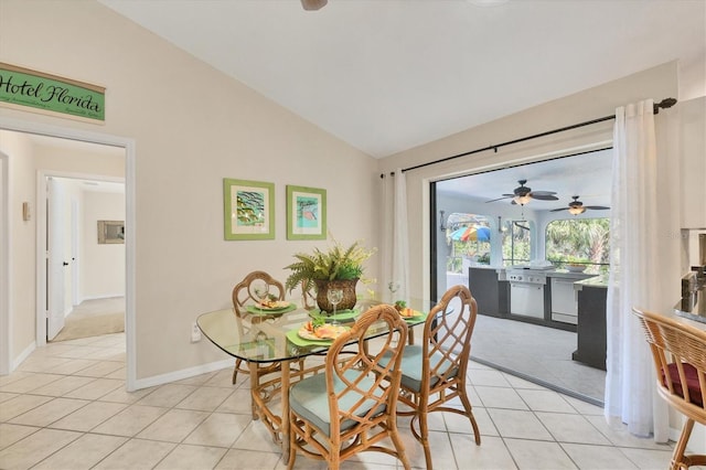 dining area featuring light tile patterned floors, baseboards, high vaulted ceiling, and a ceiling fan