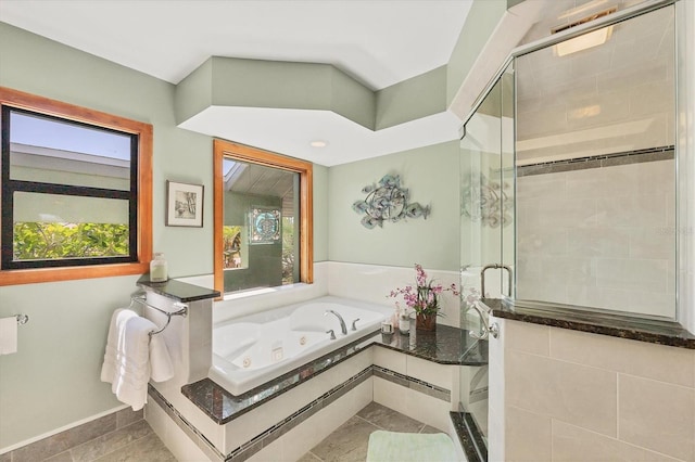 full bathroom featuring plenty of natural light, a stall shower, a jetted tub, and tile patterned flooring