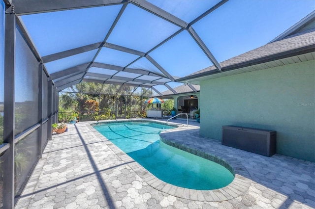 outdoor pool featuring a patio, a ceiling fan, and glass enclosure