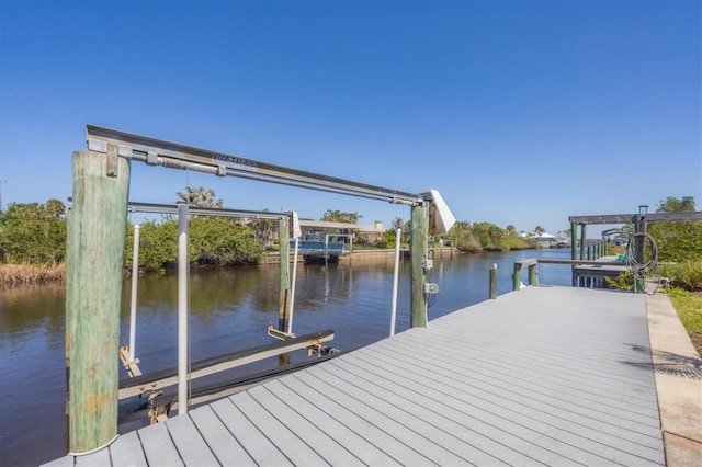 dock area with a water view and boat lift