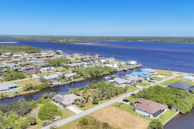 aerial view of residential area featuring a nearby body of water