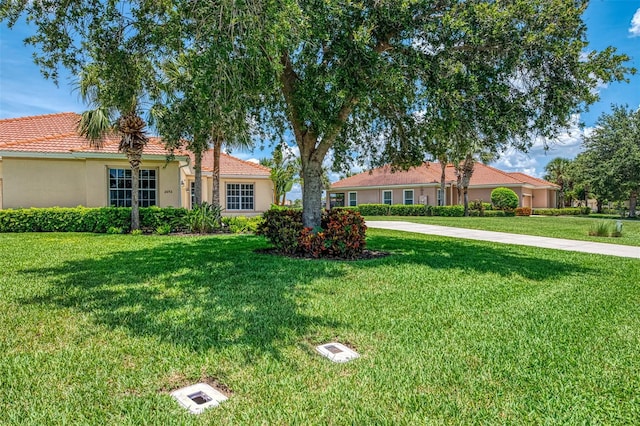 2692 Wax Myrtle Ct, Port Charlotte, FL 33953 - ranch-style house with stucco siding, a front yard, and a tile roof