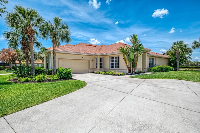 2692 Wax Myrtle Ct, Port Charlotte, FL 33953 - mediterranean / spanish-style home featuring an attached garage, concrete driveway, a front lawn, stucco siding, and a tile roof