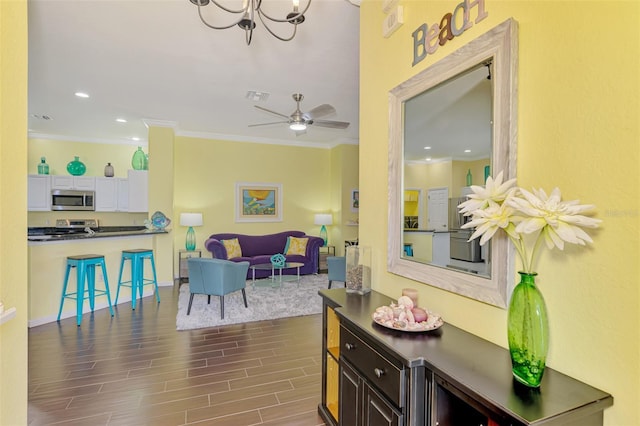2692 Wax Myrtle Ct, Port Charlotte, FL 33953 - living area featuring crown molding, dark wood-type flooring, a chandelier, recessed lighting, and baseboards