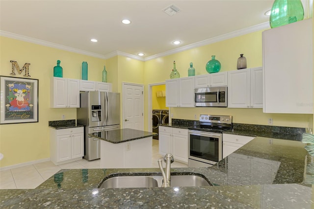 2692 Wax Myrtle Ct, Port Charlotte, FL 33953 - kitchen featuring appliances with stainless steel finishes, separate washer and dryer, a sink, dark stone counters, and light tile patterned floors