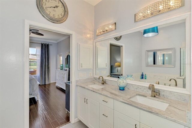 2692 Wax Myrtle Ct, Port Charlotte, FL 33953 - ensuite bathroom with crown molding, double vanity, and baseboards