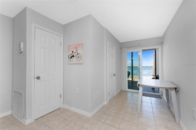 5041 N Beach Road 2A And 2B, Englewood, FL 34223 - unfurnished dining area with baseboards, light tile patterned floors, and a water view