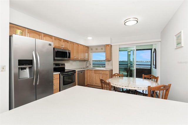 5041 N Beach Road 2A And 2B, Englewood, FL 34223 - kitchen with appliances with stainless steel finishes, light countertops, tasteful backsplash, and a sink