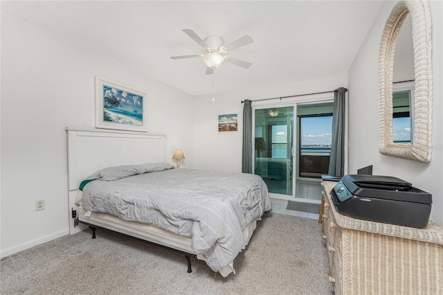 5041 N Beach Road 2A And 2B, Englewood, FL 34223 - carpeted bedroom featuring access to exterior, baseboards, a ceiling fan, and a textured ceiling